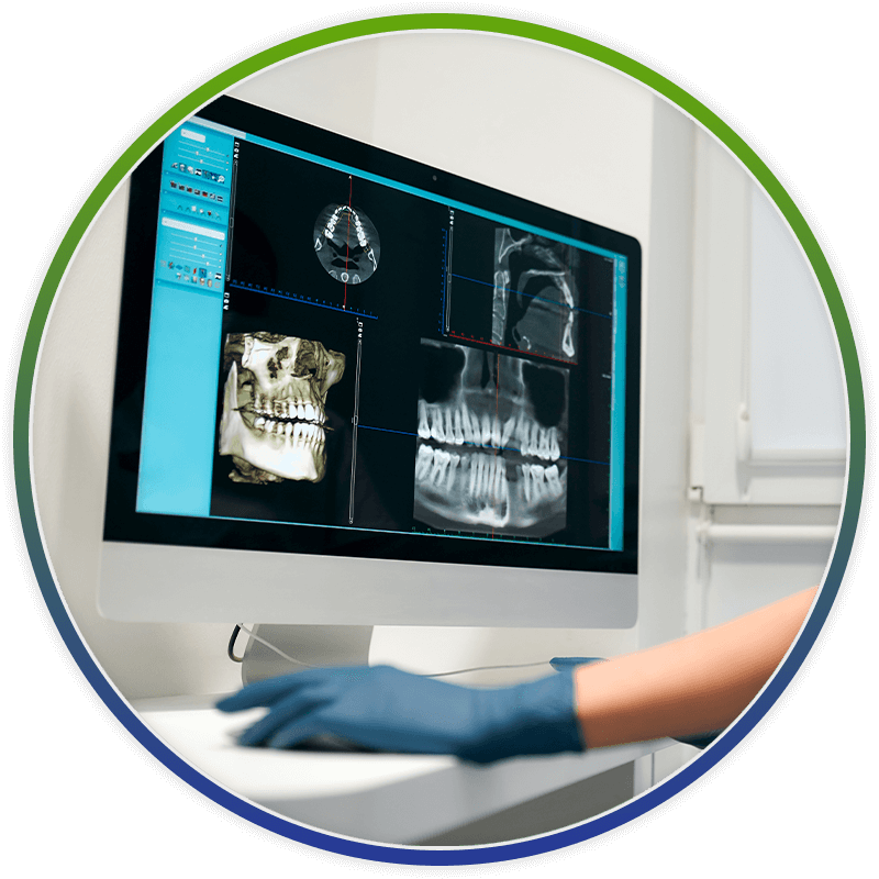 dentist using computer to look at xrays