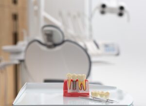 A friendly dental implant dentist is carefully examining a patient's 3D scan, while pointing to the area of focus. The environment is a modern dental office in Lake Zurich, IL. No text on image.