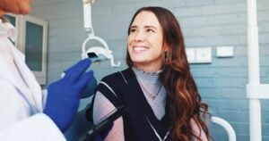 woman smiling with doctor standing nearby